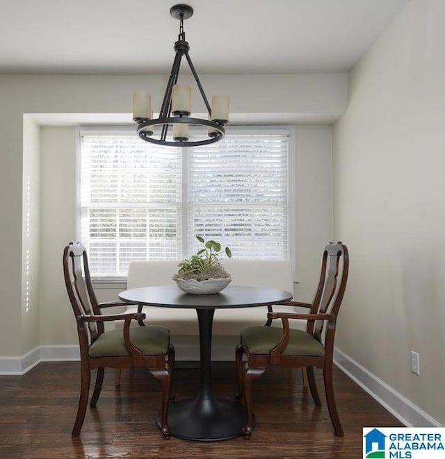 dining room featuring breakfast area, a chandelier, a healthy amount of sunlight, and dark wood-type flooring