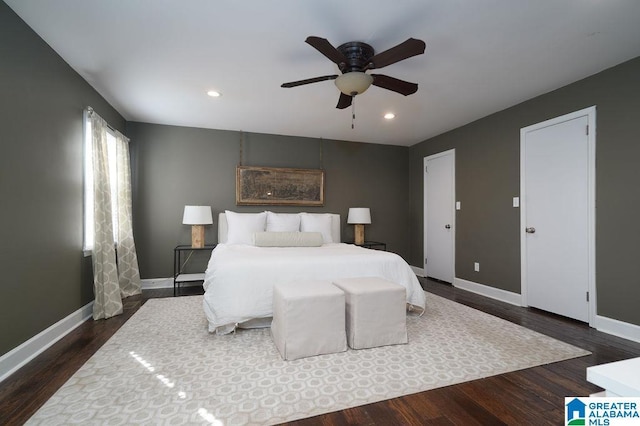 bedroom with ceiling fan and dark hardwood / wood-style floors