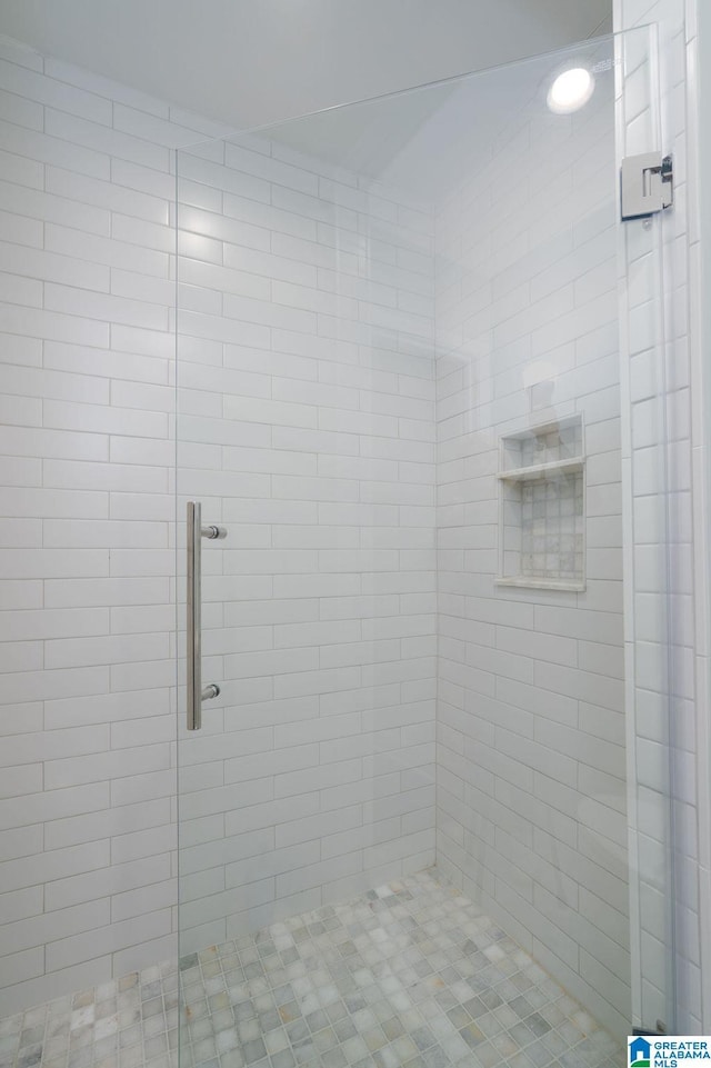 bathroom featuring a shower with door