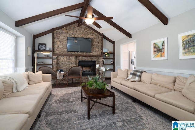 living room featuring ceiling fan, vaulted ceiling with beams, and a fireplace