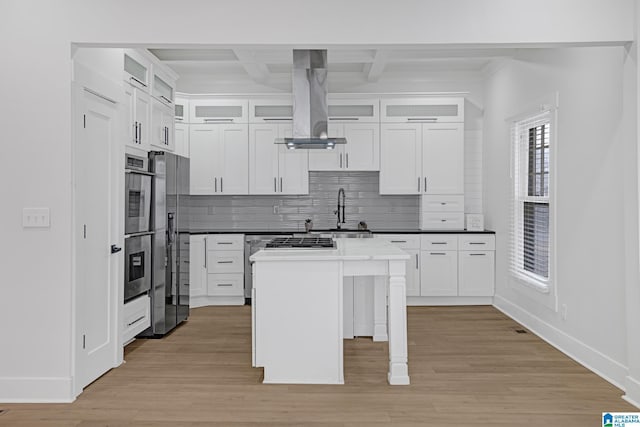 kitchen with island exhaust hood, a kitchen island, and white cabinets