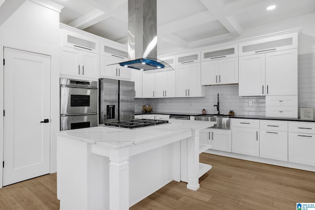 kitchen featuring island range hood, stainless steel appliances, white cabinets, and a kitchen island