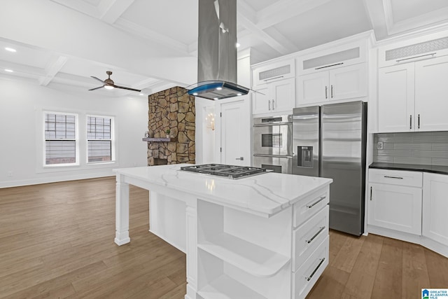 kitchen featuring white cabinets, appliances with stainless steel finishes, a kitchen island, and island range hood