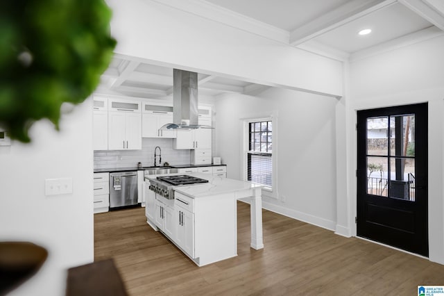 kitchen featuring appliances with stainless steel finishes, white cabinetry, a center island, coffered ceiling, and island exhaust hood