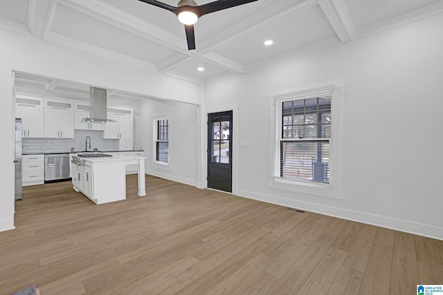 kitchen with stainless steel appliances, a kitchen breakfast bar, island range hood, white cabinets, and a kitchen island