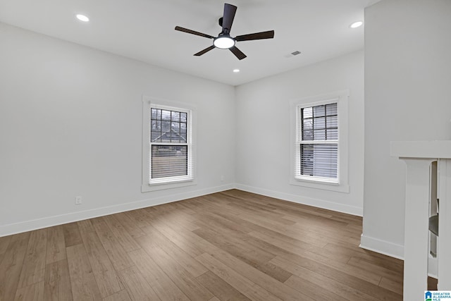 unfurnished room with ceiling fan and light wood-type flooring