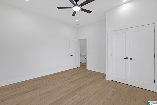 unfurnished bedroom with a closet, ceiling fan, and light wood-type flooring