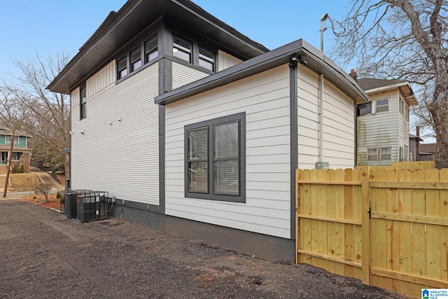 view of side of home with central AC unit