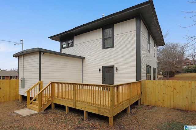 rear view of property with a wooden deck