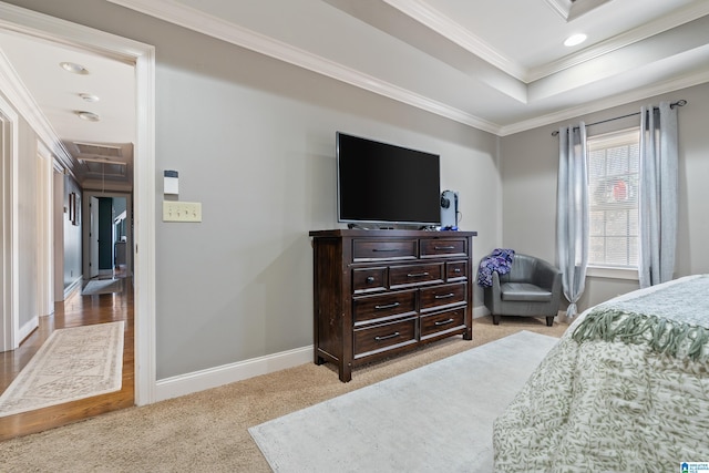 bedroom with light carpet, ornamental molding, and a tray ceiling