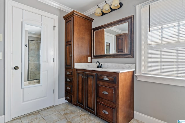 bathroom with tile patterned floors, vanity, and crown molding