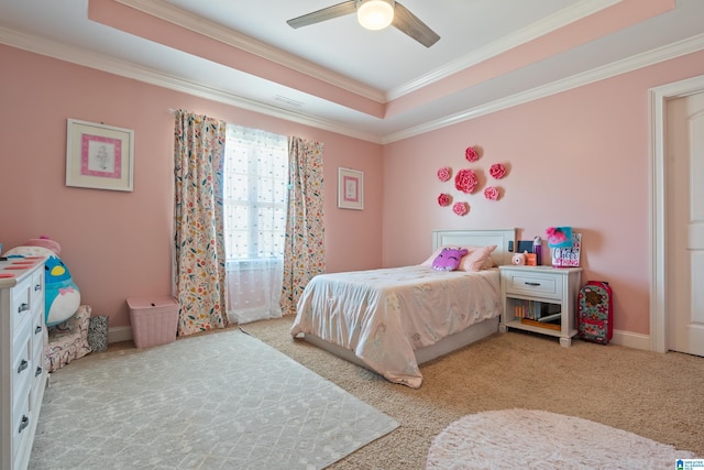 bedroom with ceiling fan, light carpet, ornamental molding, and a raised ceiling