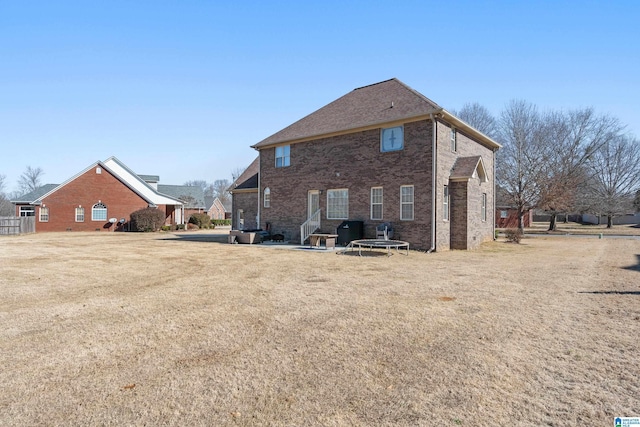 rear view of property featuring a yard