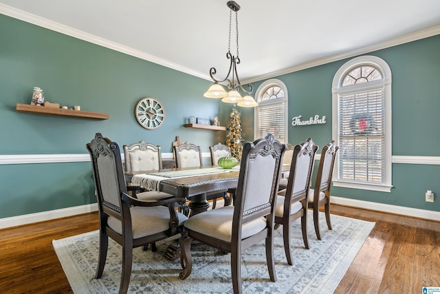 dining area featuring hardwood / wood-style flooring, a wealth of natural light, and ornamental molding