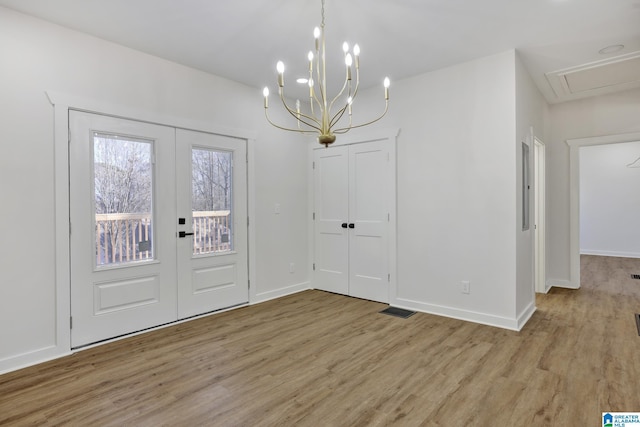 entrance foyer featuring french doors and light hardwood / wood-style flooring