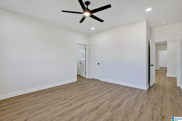 unfurnished bedroom featuring light hardwood / wood-style flooring and ceiling fan