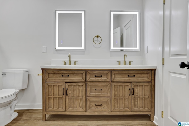 bathroom with vanity, hardwood / wood-style flooring, and toilet