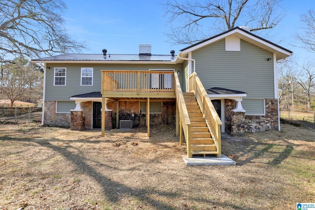 rear view of house with a deck and central air condition unit