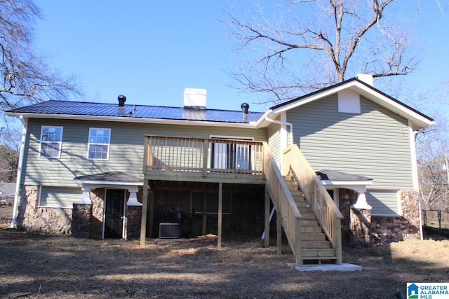 back of house with central air condition unit and a deck