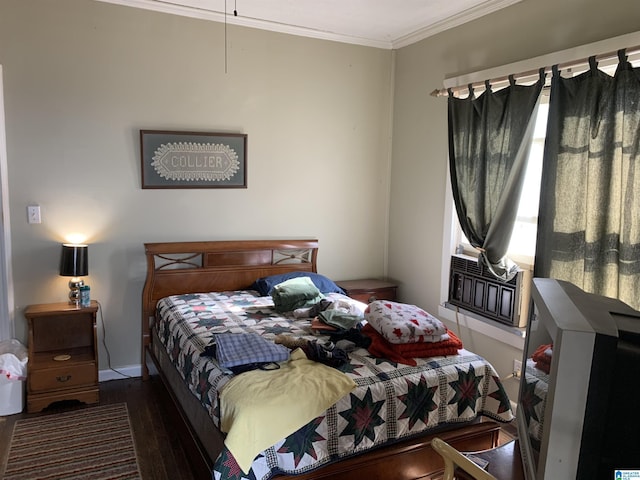 bedroom with dark hardwood / wood-style floors and crown molding