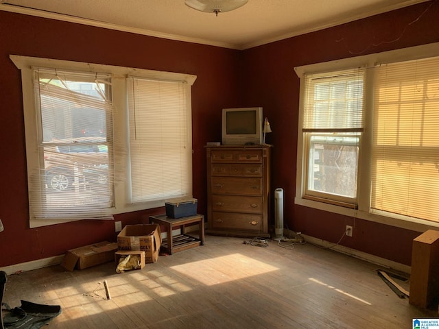 sitting room featuring a healthy amount of sunlight, crown molding, and light hardwood / wood-style flooring