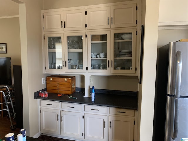 kitchen featuring white cabinetry and stainless steel fridge