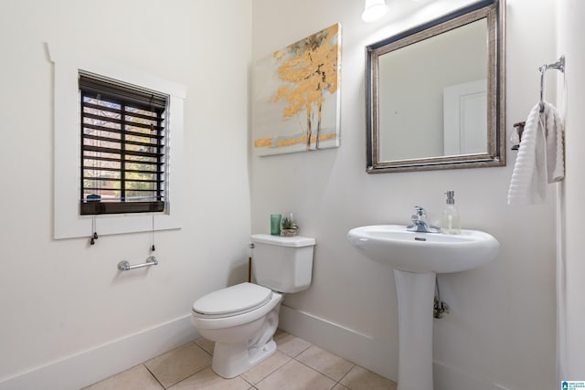 bathroom with toilet and tile patterned flooring