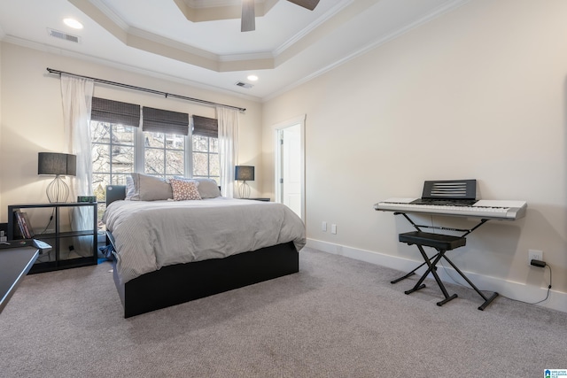 carpeted bedroom featuring ceiling fan, ornamental molding, and a raised ceiling