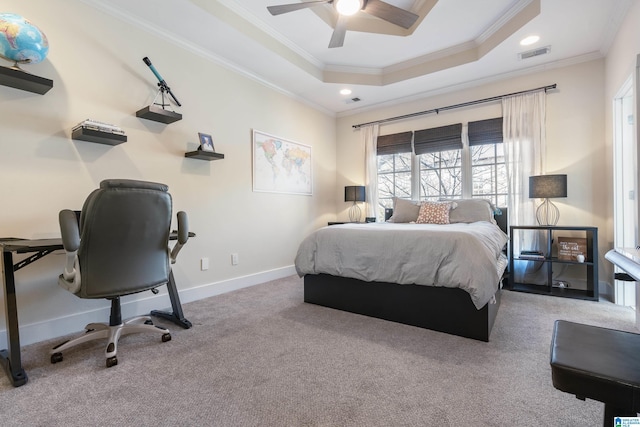 carpeted bedroom featuring ceiling fan, ornamental molding, and a raised ceiling