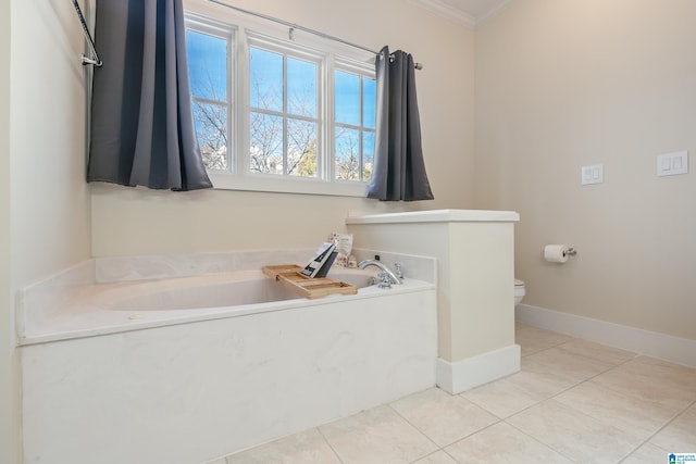 bathroom with a washtub, tile patterned floors, ornamental molding, and toilet