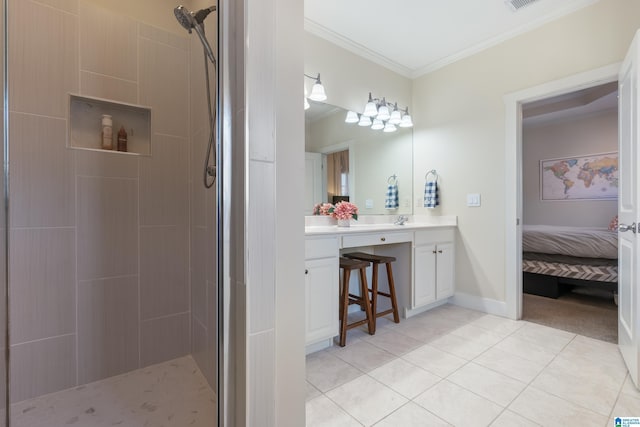 bathroom with vanity, ornamental molding, tile patterned floors, and tiled shower