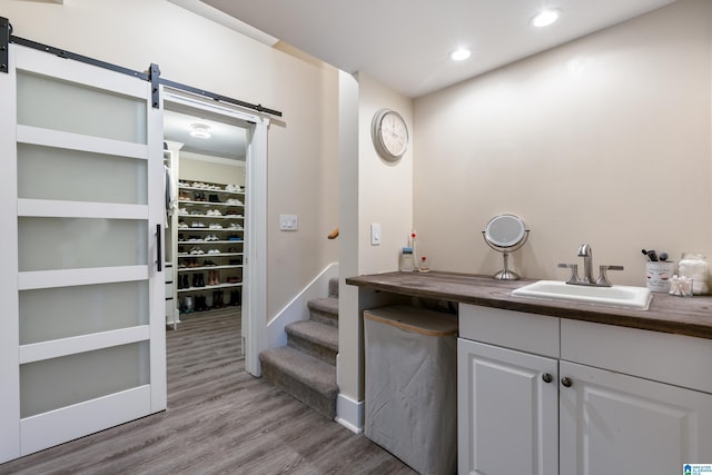 interior space with vanity, crown molding, and hardwood / wood-style flooring