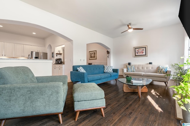 living room with ceiling fan and dark hardwood / wood-style floors