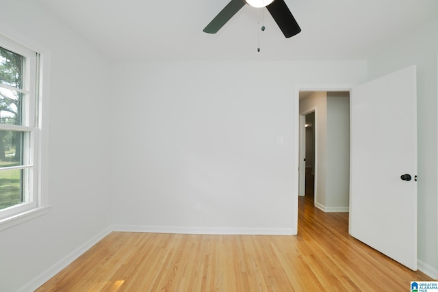 unfurnished room with ceiling fan, a wealth of natural light, and light hardwood / wood-style flooring