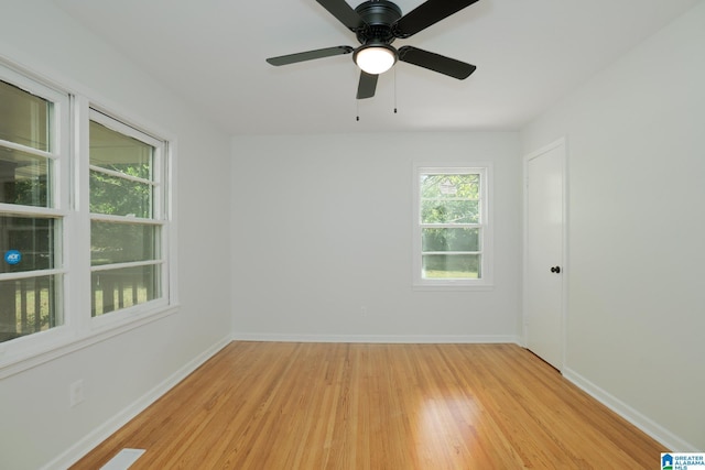 spare room featuring light wood-type flooring and ceiling fan