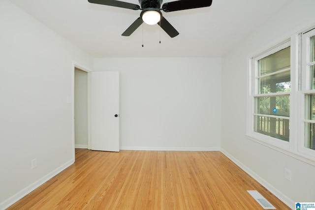 empty room featuring ceiling fan and light hardwood / wood-style flooring