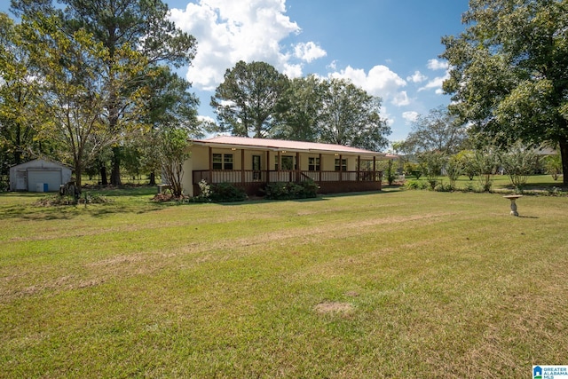 view of front facade with a front yard and covered porch