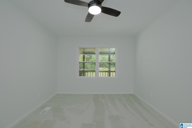 unfurnished room with ceiling fan and carpet flooring