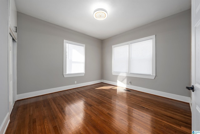 unfurnished room featuring dark hardwood / wood-style flooring