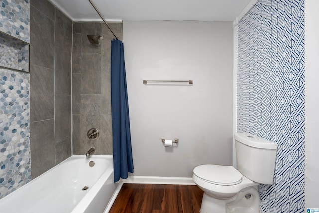 bathroom featuring hardwood / wood-style flooring, toilet, and shower / tub combo