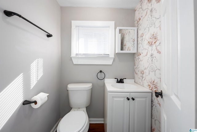 bathroom featuring toilet and vanity