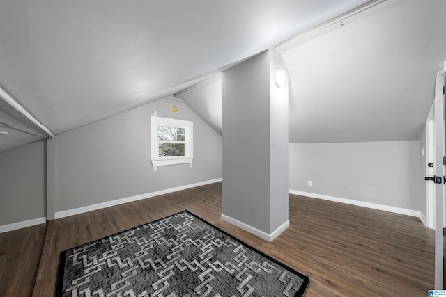 bonus room with lofted ceiling and dark hardwood / wood-style floors