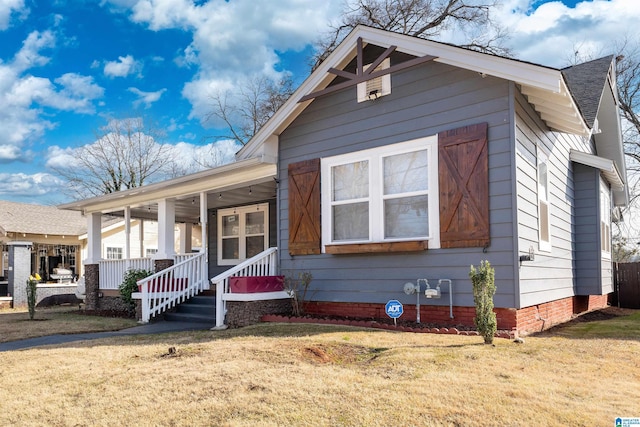 bungalow-style house featuring a porch and a front yard