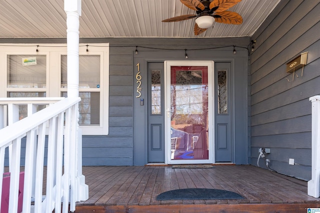 entrance to property with ceiling fan and covered porch