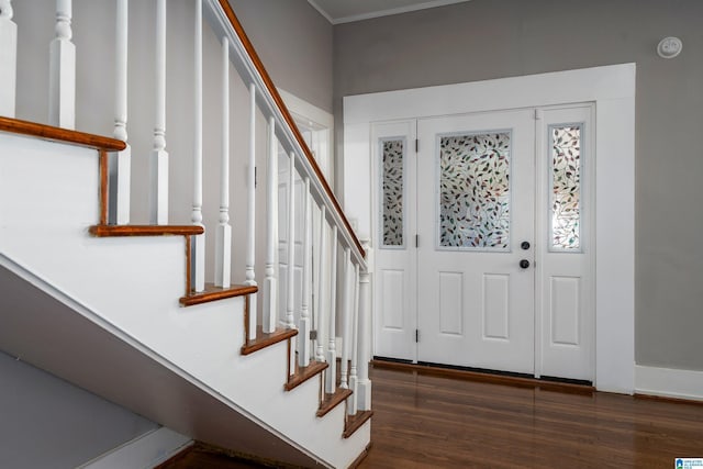 foyer entrance featuring dark hardwood / wood-style flooring and ornamental molding