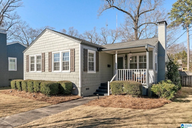 ranch-style house with covered porch and a front lawn