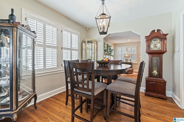 dining area featuring hardwood / wood-style flooring, a chandelier, and plenty of natural light