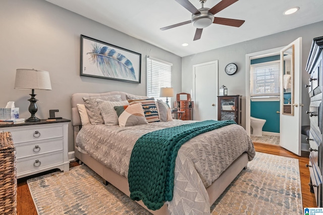 bedroom featuring ceiling fan, multiple windows, and wood-type flooring