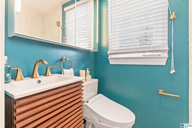 bathroom featuring toilet and vanity