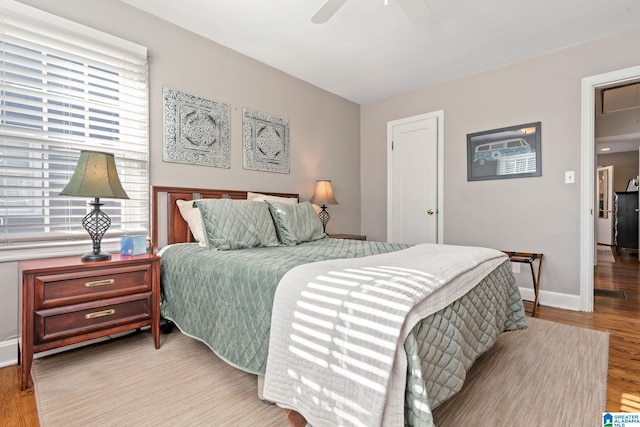 bedroom with ceiling fan and light wood-type flooring